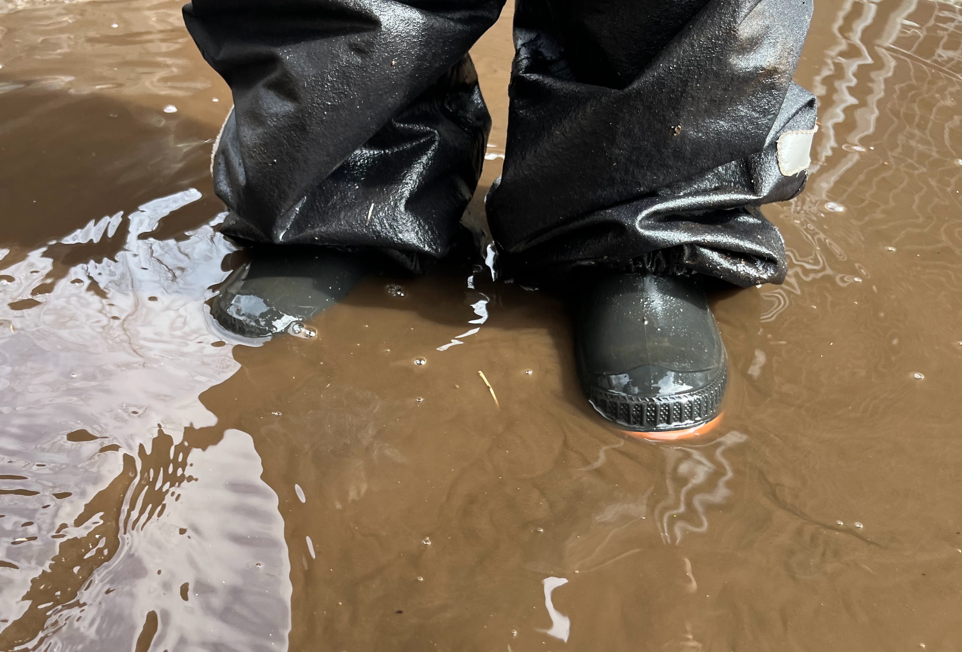 Child playing in a mud puddle