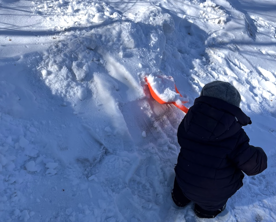 Child shoveling snow