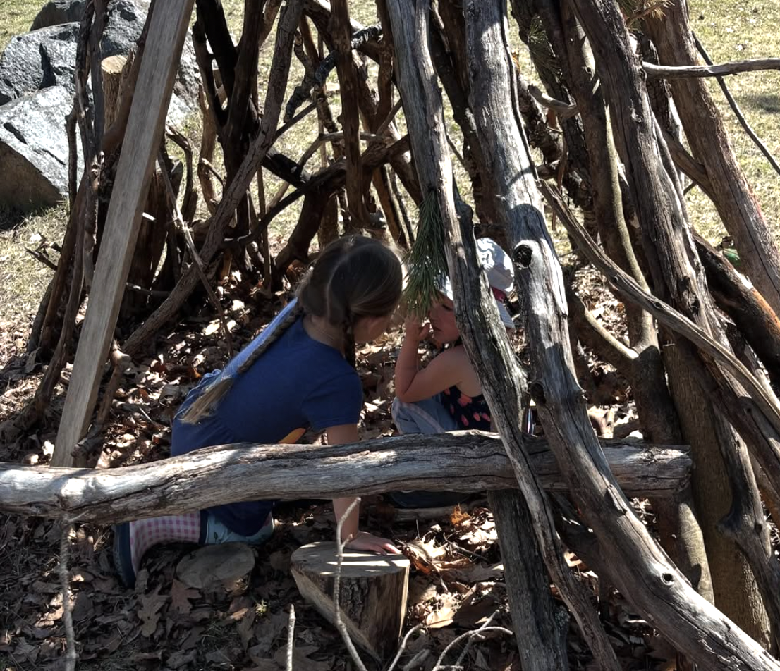 Children playing in a stick fort at Duluth Nature School